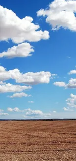 Mobile wallpaper of blue sky and white clouds over an open field for a serene touch.