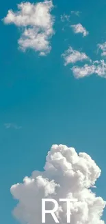 Fluffy clouds in a blue sky, peaceful wallpaper.