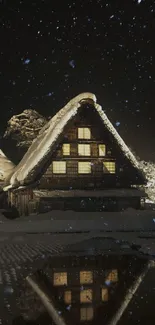 Snowy cabin at night with reflection on water.