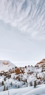 Snowy mountain landscape under a blue sky, perfect for serene winter backgrounds.