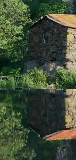 Stone cottage with pond reflection and lush greenery.