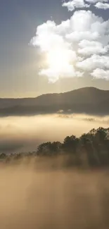 Sunrise over misty hills with clouds in the sky.