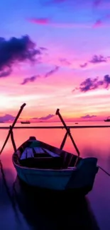 Serene boat with vibrant sunset reflecting on calm waters.