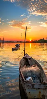 Boat floating on calm waters during a vibrant sunset, with orange and blue hues.