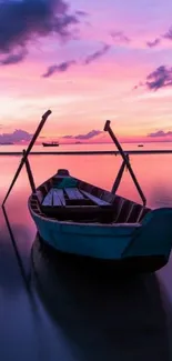 Serene boat on calm waters at sunset with pink and purple hues.