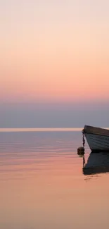 Peaceful sunset over calm waters with a boat, featuring pink and orange hues.