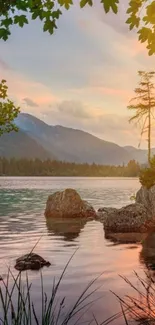 Serene lake at sunset with mountain views.