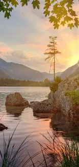 Tranquil sunset view over lake with mountains and trees, perfect for phone wallpaper.