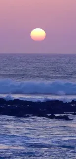 Purple sky sunset over ocean with gentle waves.