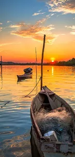 Tranquil sunset over a lake with boats and vibrant orange sky.