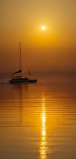 Sailboat at sunset with orange reflections on calm water.