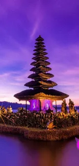 Purple sunset over a temple by a tranquil lake.