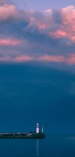 Lighthouse under a vivid pink and blue twilight sky.