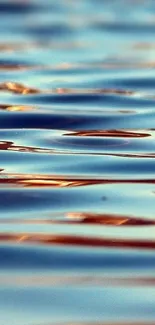 Mobile wallpaper of tranquil water ripples with blue and golden reflections.