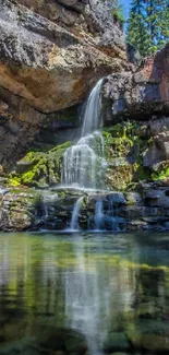 Tranquil waterfall amidst rocky cliffs and greenery for mobile wallpaper.