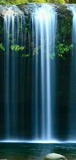 Serene waterfall with lush green surroundings in a tranquil setting.