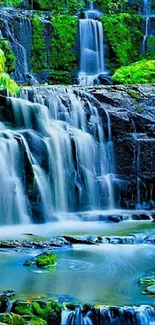 Vibrant waterfall with lush greenery wallpaper.