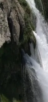 Mobile wallpaper of a serene waterfall cascading down rocks.