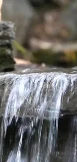 Serene waterfall flowing over rocky ledge.