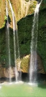 Cascading waterfall over lush green cliffs in vibrant nature setting.