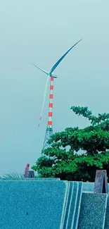 A serene landscape featuring a tall windmill and lush greenery.