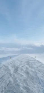 Tranquil winter road under clear blue sky.