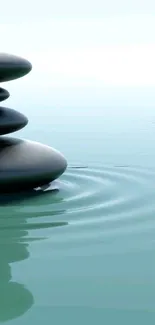 Serene mobile wallpaper with stacked Zen stones on rippling water surface.