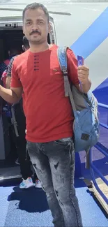 Traveler in red shirt boarding airplane