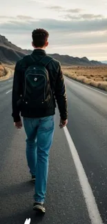 Man walking on an open road with a mountain landscape.