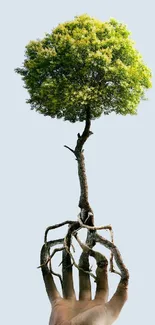 Hand holding a tree blending into roots against a light gray background.