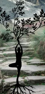 Black tree silhouette on a stone path with green surroundings.