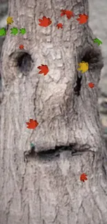 Brown tree trunk with a carved face and artistic design.