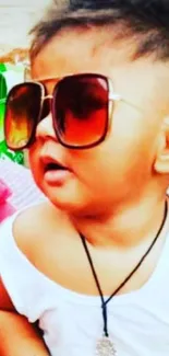 Cute baby in sunglasses enjoying a sunny day at the beach.