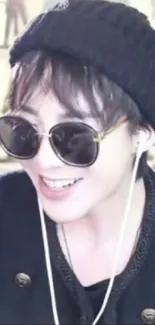 A person wearing a black beanie and sunglasses, exuding a cool fashion vibe.