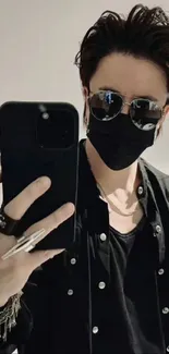 Sleek black outfit mirror selfie with accessories and sunglasses.