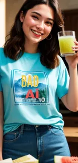 Woman in blue t-shirt holding a green drink, smiling indoors.