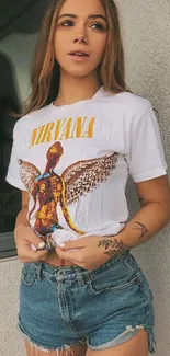 Fashionable woman in Nirvana tee and denim shorts.