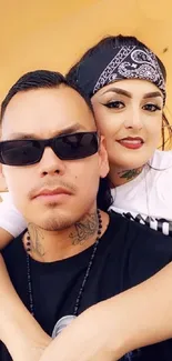 Chic couple with sunglasses and tattoos in stylish mobile wallpaper.