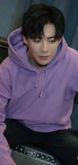 Person wearing a stylish lilac hoodie sitting.