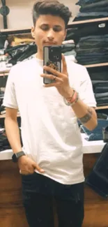 Mirror selfie of a person in casual attire inside a clothing store.