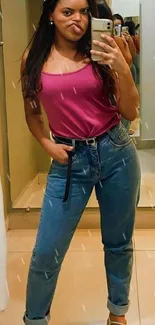 Woman in pink top taking a mirror selfie.