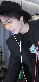 A trendy musician in a studio with headphones and sunglasses.