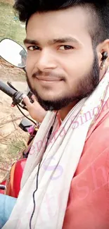 Young man smiling on a bike outdoors.