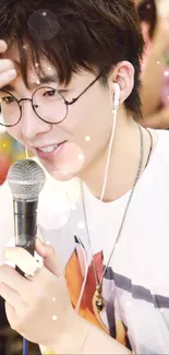 Young trendy singer with microphone, wearing glasses, and casual attire.