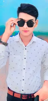 Stylish man with sunglasses on a vibrant background.