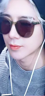 Person with sunglasses and headphones on a stylish mobile wallpaper.