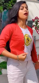 Woman in stylish red and white outfit, outdoors.