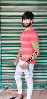 Man in coral shirt with rustic green shutter.