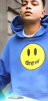 Vibrant blue urban hoodie with smiley face design.