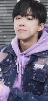 Young individual in trendy purple hoodie with denim jacket.